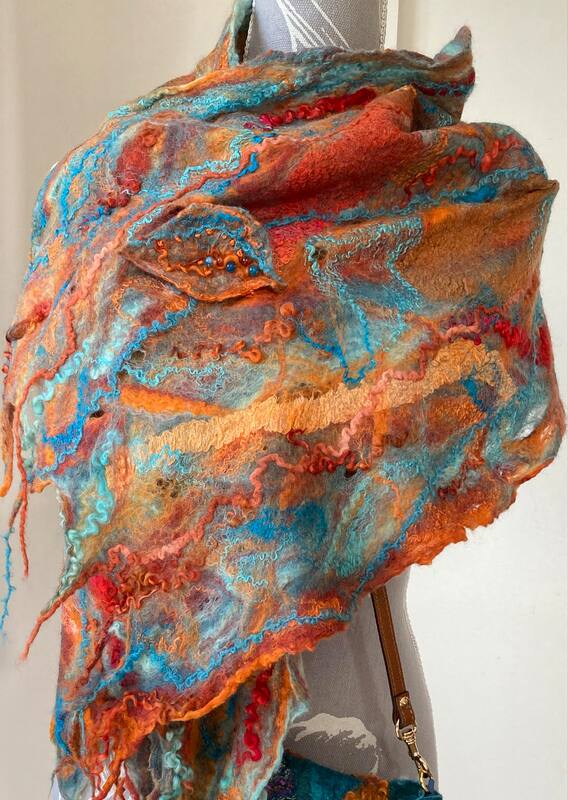 Orange and blue felted shawl on mannequin