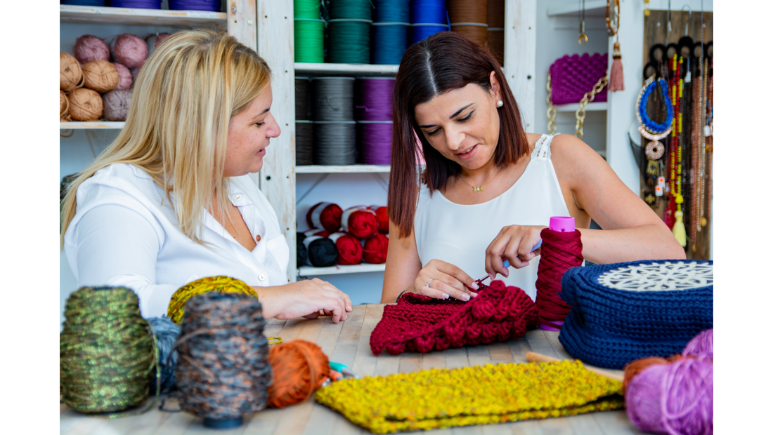 two women crocheting in a yarn shop