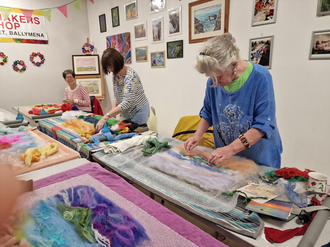 2 women stood, concentrating on felting their pictures in Midtown Makers workshop space