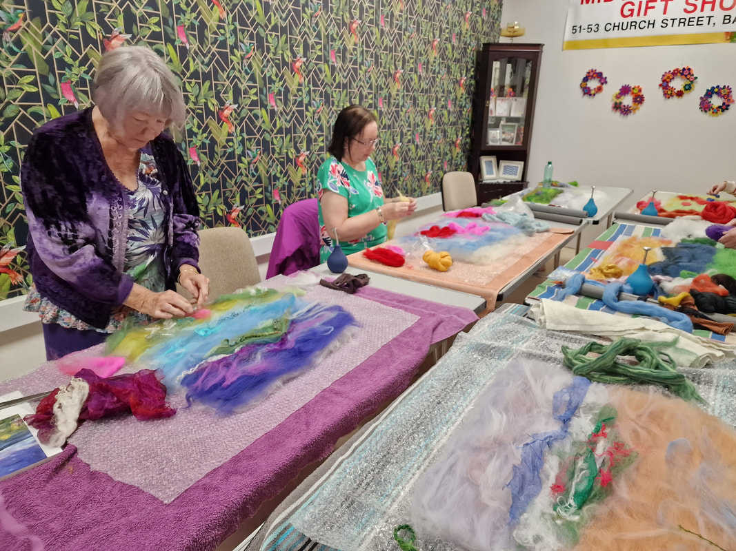 two women working on felting pictures in Midtown Makers workshop space